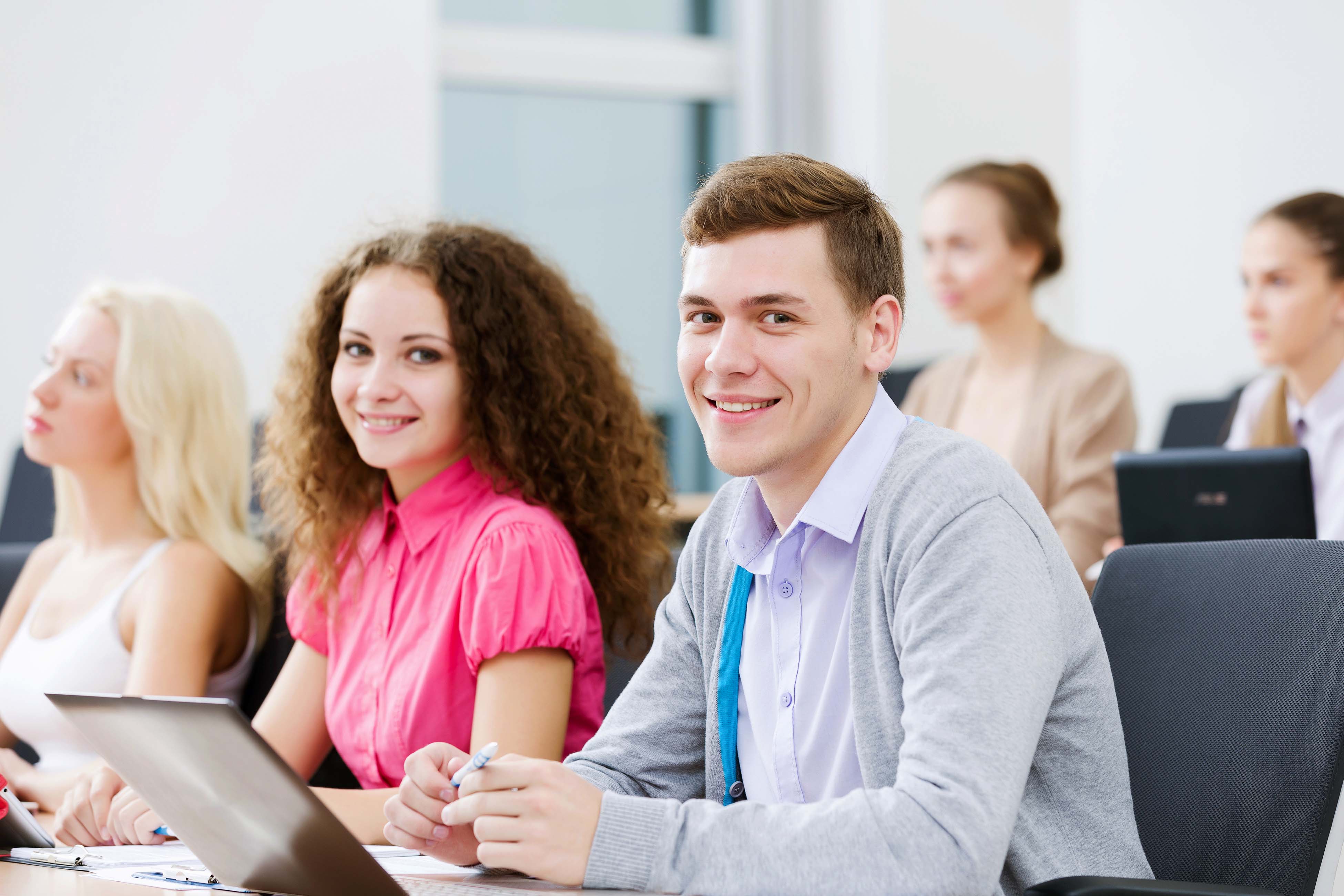 Young people sitting in classroom at lecture